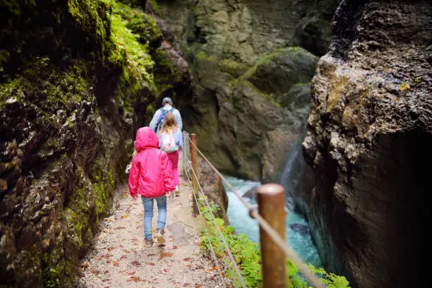 Photo of Blue water flowing in the Partnach Gorge or Partnachklamm, incised by a mountain stream in the Reintal valley near Garmisch-Partenkirchen town