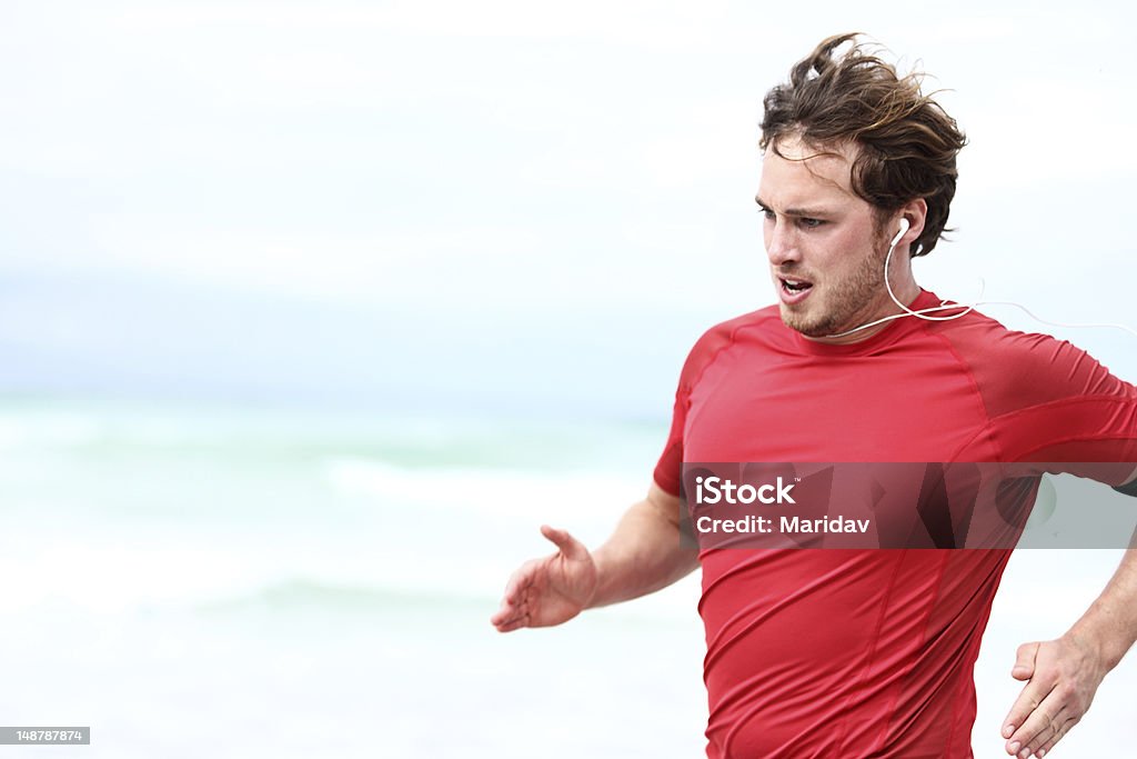 Running man Running man. Runner athlete in outdoor workout sprint. Young sport man training outdoors in beach.. Click for more: 20-29 Years Stock Photo