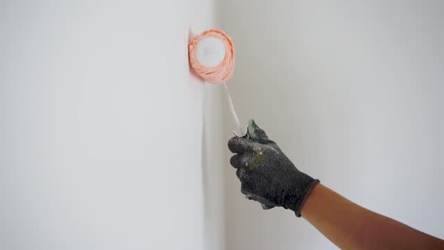 Wall painting technique with a roller.  Person applying color to a wall