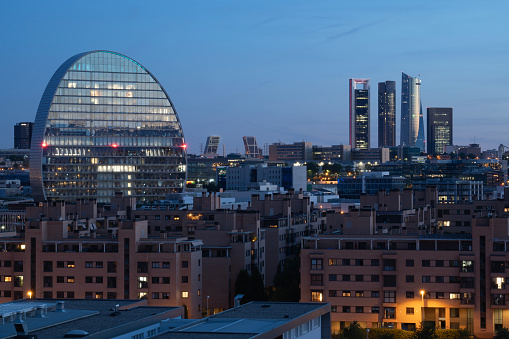Panoramic view of Madrid city, Spain after sunset with night lights and blue sky.