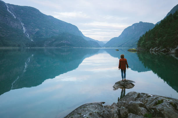 istock Man standing near the lake in Norway 1487885607