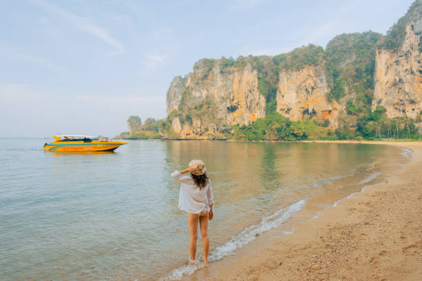 istock Woman walking on Railey beach and looking at stunning scenery 1487887176