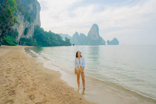 istock Woman walking on Railey beach and looking at stunning scenery 1487887185