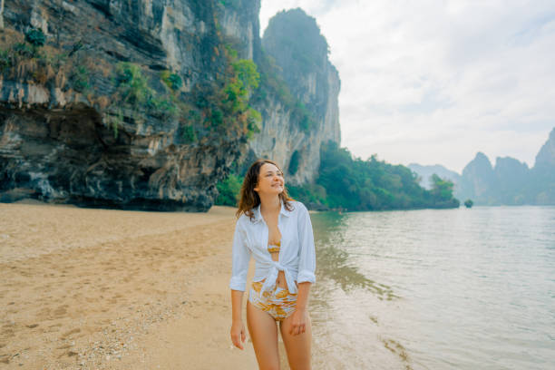 istock Woman walking on Railey beach and looking at stunning scenery 1487887190