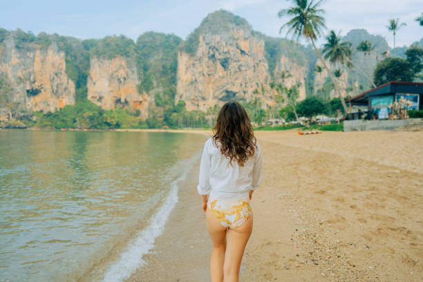 istock Woman walking on Railey beach and looking at stunning scenery 1487887212