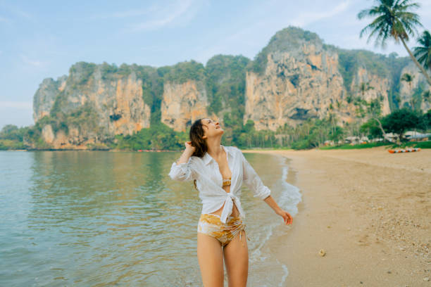 istock Woman walking on Railey beach and looking at stunning scenery 1487887213