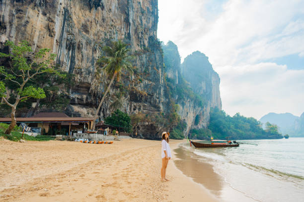 istock Woman walking on Railey beach and looking at stunning scenery 1487887290