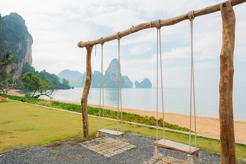 Swing on the background of scenic view of idyllic tropical beach