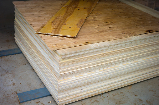 a stack of brand new plywood, indoor shot, no people