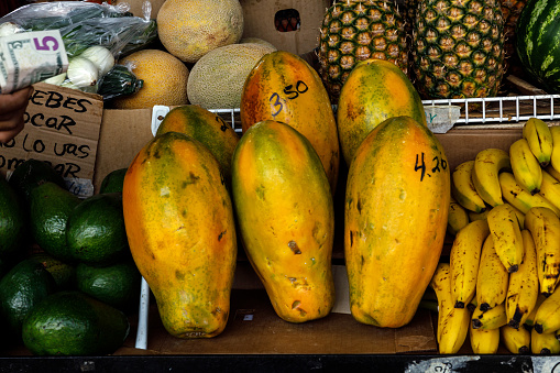 Papaya and pineapples with ornamental design on a fruit market
