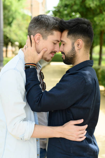 istock Loving gay couple hugging in park 1487892143