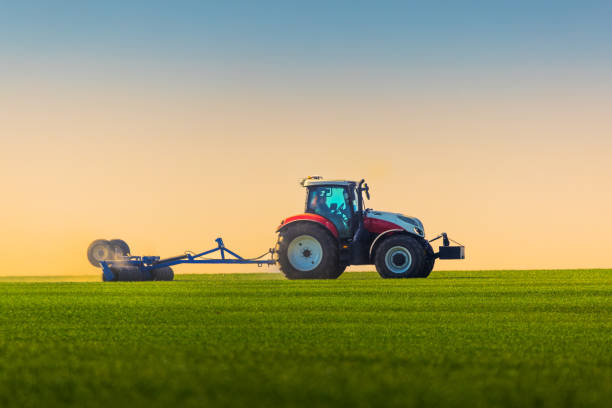 istock Tractor with a roller tillage on spring field. Soil rolling supports germination and is the basis for good harvesting, organic farming and agronomy 1487894641