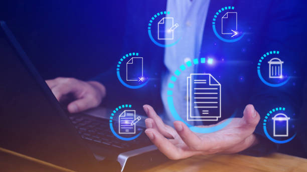 istock Businessman holding multimedia type of modern buttons with virtual background, Document Management System (DMS), searching and managing corporate files information. 1487894709