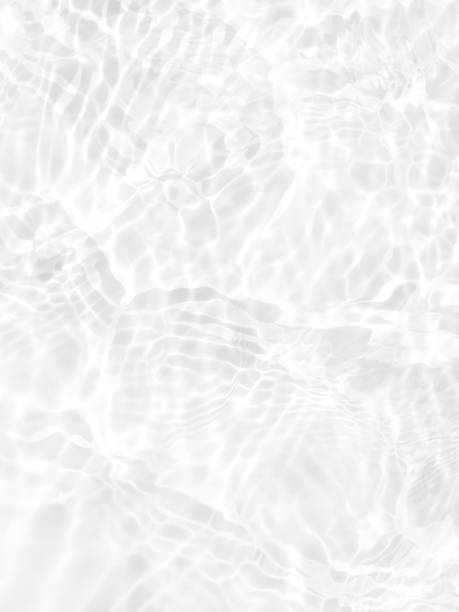 istock White water with ripples on the surface. Defocus blurred transparent white colored clear calm water surface texture with splashes and bubbles. Water waves with shining pattern texture background. 1487895267