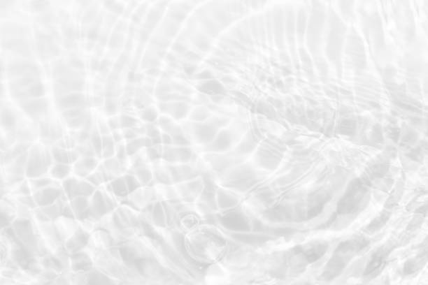 istock White water with ripples on the surface. Defocus blurred transparent white colored clear calm water surface texture with splashes and bubbles. Water waves with shining pattern texture background. 1487895334