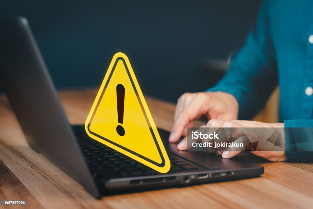 Using Computer Warning Sign Man Using A Computer Laptop With Triangle Caution Warning Sign For ...