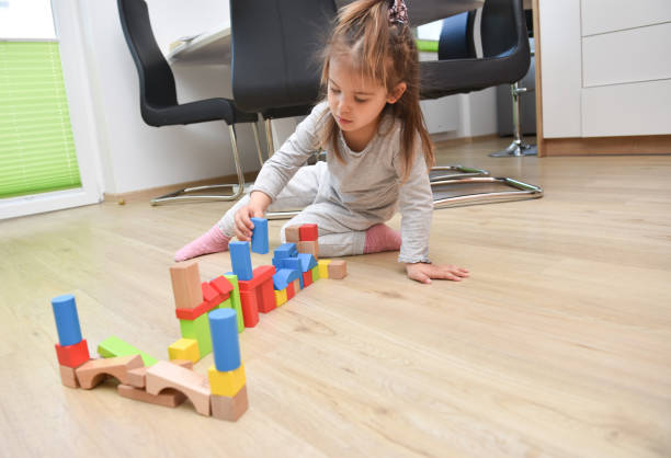 istock Child playing with toy blocks 1487898640