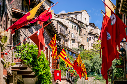 Dozens of medieval flags decorate the Rione San Pietro in the historic heart of Assisi in Umbria
