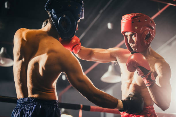 istock Boxer use various punch combinations, including the jab, hook, uppercut, cross, swing, straight. Getting in close to make opponent on ropes and knockout. Boxing champions win the round in boxing ring 1487900707
