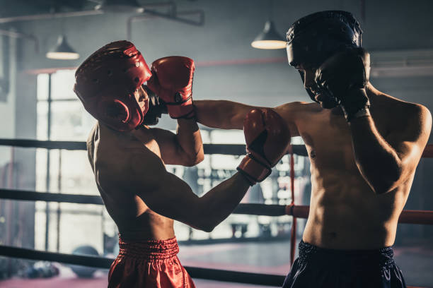 istock Boxer use various punch combinations, including the jab, hook, uppercut, cross, swing, straight. Getting in close to make opponent on ropes and knockout. Boxing champions win the round in boxing ring 1487901251