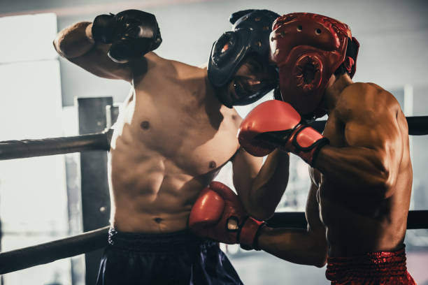 istock Boxer use various punch combinations, including the jab, hook, uppercut, cross, swing, straight. Getting in close to make opponent on ropes and knockout. Boxing champions win the round in boxing ring 1487901504