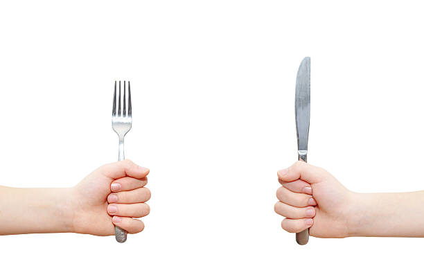 hands holding fork and knife stock photo