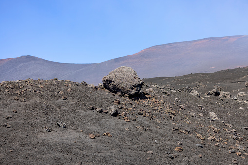 Beautiful general view Torre del Filosofo of the slopes of  volcano Mount Etna on the sunny day, Sicily, Italy. Stones and solidified lava, no vegetation