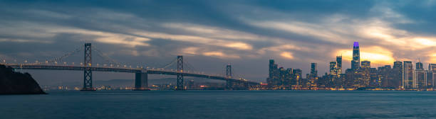 istock Oakland Bay Bridge and Downtown San Francisco at Sunset Panorama 1487905074