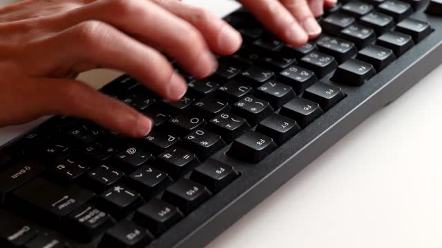 Typing on the black computer keyboard
