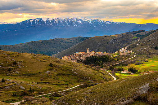 view of village Santo Stefano di Sessanio in Abruzzo in the Gran Sasso National Park and Majella Mountains with its rolling hills and high ranges at sunset romantic