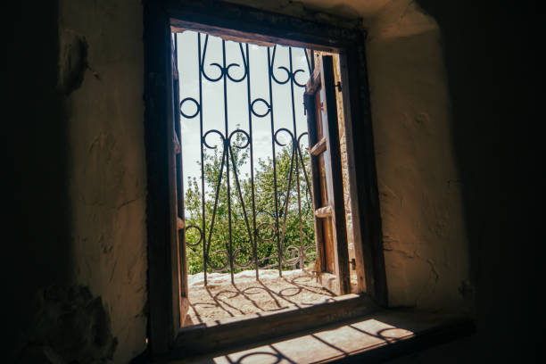 istock antique wooden window in a stone wall 1487907820