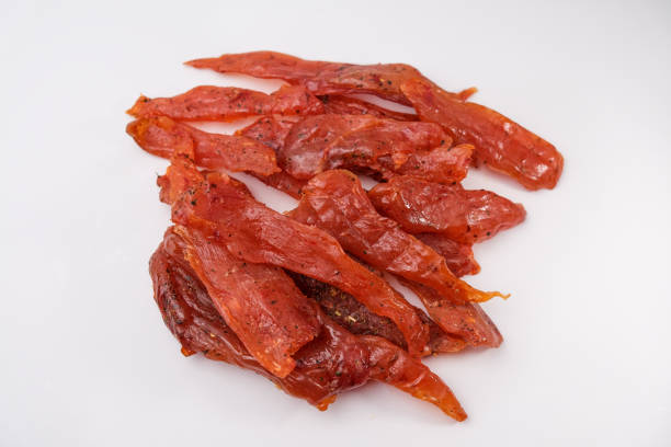 istock Chicken jerky. dried chicken meat isolated on white background. Beer snack 1487909072