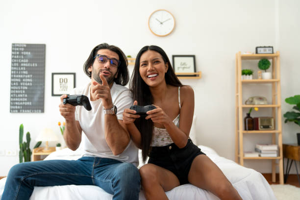 istock Ethnicity couple use  game controller playing excited video game in bedroom 1487912946