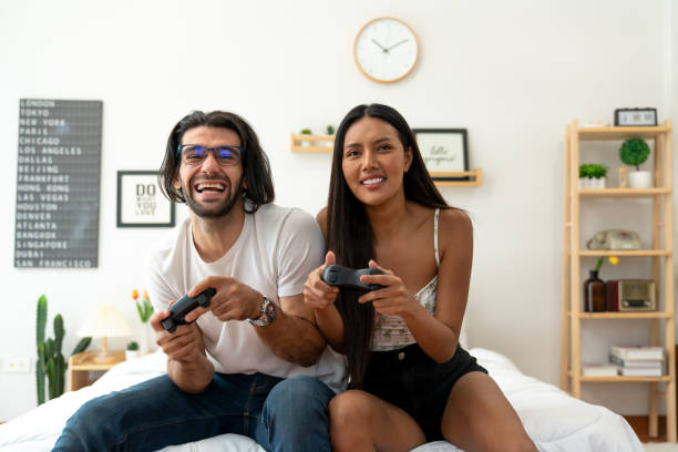 istock Ethnicity couple use  game controller playing excited video game in bedroom 1487912948