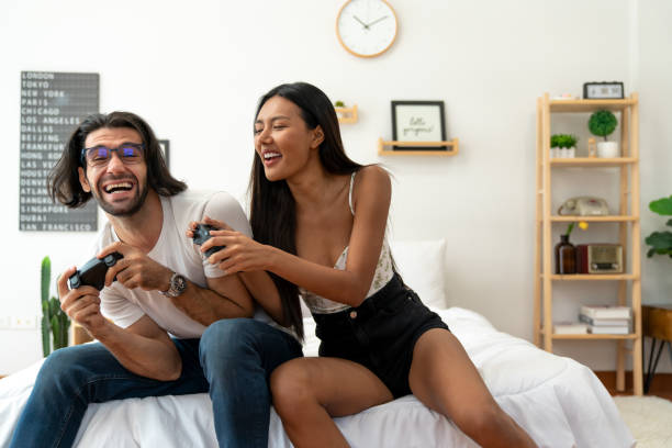 istock Ethnicity couple use  game controller playing excited video game in bedroom 1487912956