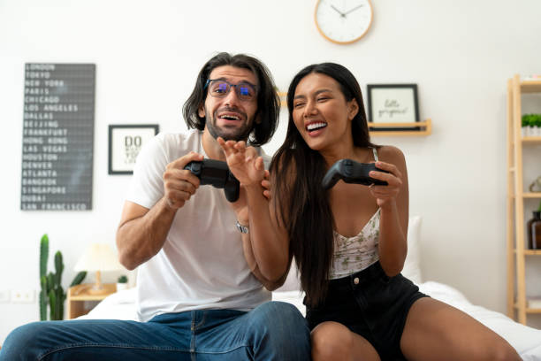 istock Ethnicity couple use  game controller playing excited video game in bedroom 1487912959
