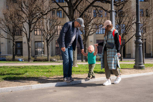 istock Two parents on the walk with son at sunny day 1487913044