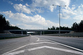 Empty multiple-lane highway at sunny day with overpass road, low angle view
