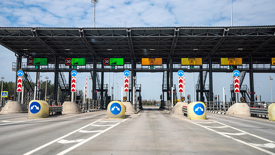 Approaching to a toll collection point at a multi-lane highway at sunny day.