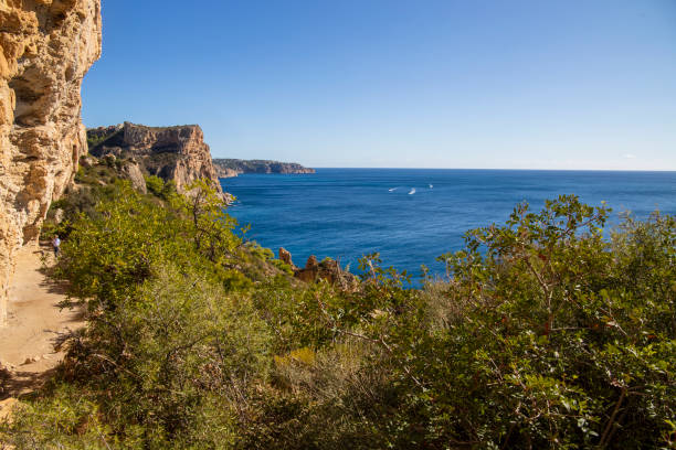istock Cliffs route in Benitachell over Moraig beach in Alicante province Spain 1487918891