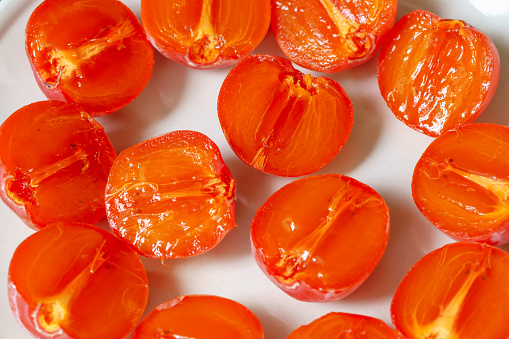 Multiple persimmons lined up on the tableMultiple persimmons lined up on the table