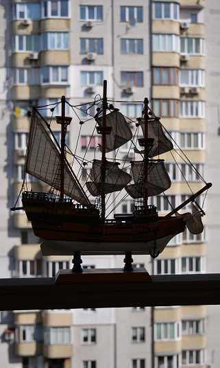 Defocused Cityscape Panorama With Wooden Sailing Ship Model On A Foreground