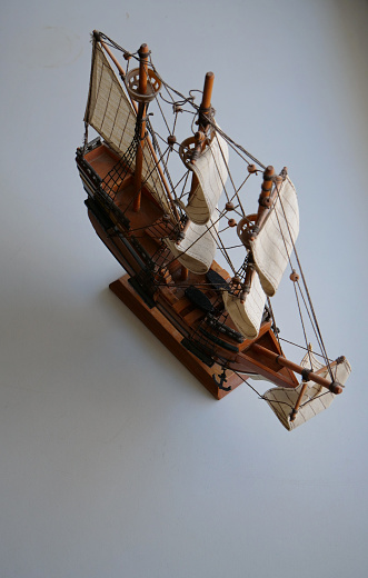 Scale Model Wooden Ship On A White Surface Isolated