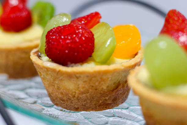 istock selective focus of Fruit tartlets dessert or fruit pie assorted. Delicious pastry sweets pies. 1487928368