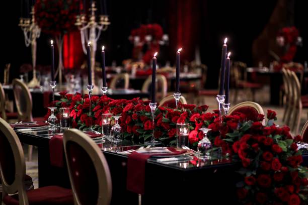 istock Opulent wedding setting elegantly adorned with vivid red roses and candles. 1487930551