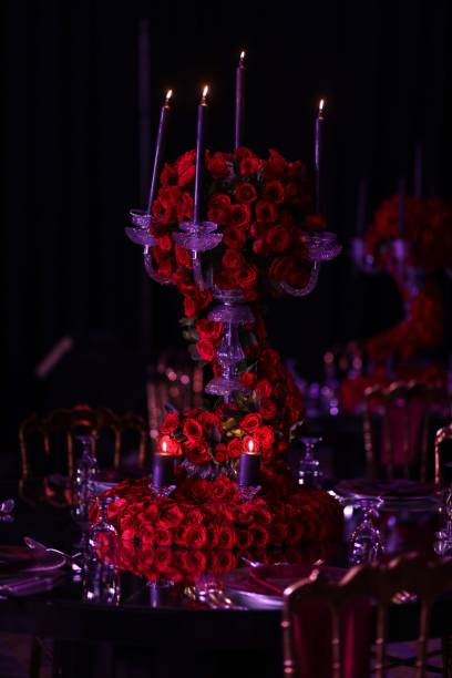 istock Beautiful candle holder adorned with red roses for a wedding ceremony. 1487930554