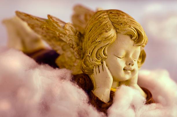 istock Angel resting on clouds and enjoying the sun head 148793418