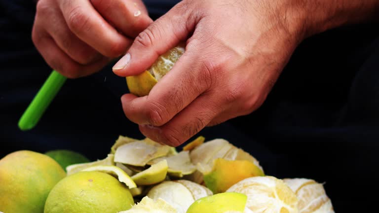 Men Peeling Off Sweet Lime Skin