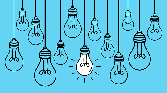 Hanging light bulbs with one glowing on blue background. Concept of idea