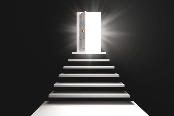 istock Stairway to black door with lighted exit in dark room. 1487944136